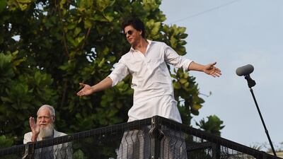 Letterman went for a reserved wave, while Khan greeted the crowd with open arms. AFP