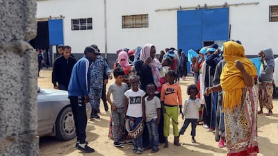 Migrants gather to meet Antonio Guterres during his visit to Ain Zara detention centre for migrants. AFP
