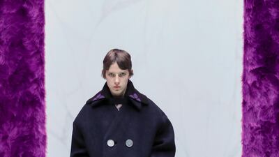 A collarless pea coat is worn over patterned long johns at Prada's autumn / winter 2021 show. Courtesy Prada