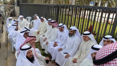 Kuwaiti opposition MPs gather outside the parliament building in Kuwait. AFP