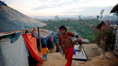 A Rohingya refugee girl carries a water jar at the Balukhali camp in Cox's Bazar, Bangladesh. Reuters