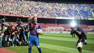 Cesc Fabregas waves to fans at Camp Nou.