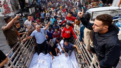 Mourners gather on Wednesday around members of the Abu Dalal family killed in an overnight Israeli attack on their home in Nuseirat, central Gaza. Reuters