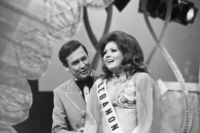 Georgina Rizk, from Beirut, Lebanon, reacts after being named Miss Universe as pageant host Bob Barker talks to her at the Miami Beach Auditorium on July 24, 1971. AP