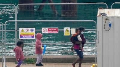 A migrant and three children arrive in Kent on September 26, 2023. PA