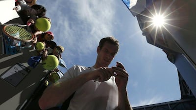 Andy Murray signs autographs after winning his first round match against Germany's Alexander Zverev at the Australian Open tennis tournament at Melbourne Park, Australia, January 19, 2016. REUTERS/Jason Reed
