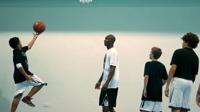 LA Lakers NBA player Kobe Bryant (C) leads a training session at the Gems American Academy in Abu Dhabi on September, 26, 2013. AFP