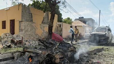 Somali security officers gather at the scene of a car bomb attack at the base for the African Union forces in Mogadishu on July 26, 2016. Said Yusuf Warsame / EPA