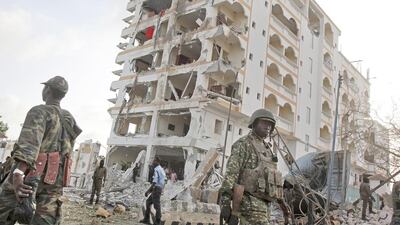 An African Union soldier walks past the scene of destruction following a suicide car bomb attack on the Jazeera Palace hotel in the Somali capital, Mogadishu. Farah Abdi Warsameh/AP Photo