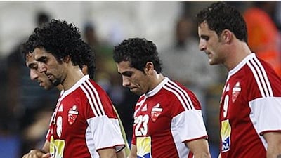 Dejected Al Ahli players trudge off the pitch at the Mohammed bin Zayed Stadium after their defeat to Auckland City.