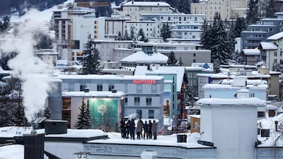 Security personnel stand on a rooftop for a briefing ahead of WEF. Bloomberg