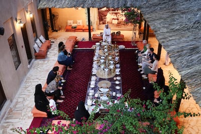 Emirati cultural representative Youssef Al Mannai of the Sheikh Mohammed Centre for Cultural Understanding speaks to a group of foreigners during an iftar to introduce tourists and visitors to the culture of Emirati iftar during Ramadan in Dubai, on March 31, 2023. Reuters