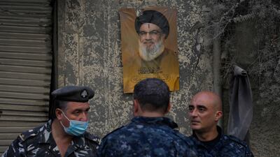 Lebanese police stand in front of a portrait of the late Hezbollah leader Hassan Nasrallah in Beirut on Saturday. AP