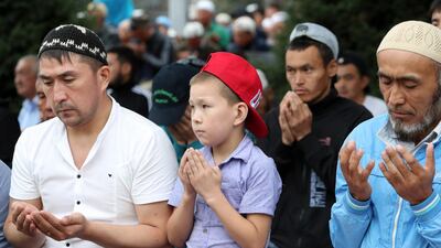 Kyrgyz people pray during at the central square in Bishkek, Kyrgyzstan. EPA