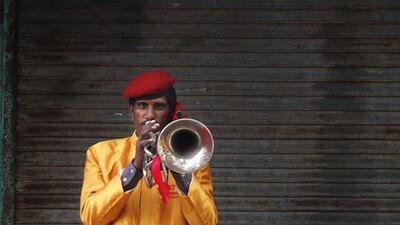 Bholu Ram, 40, from Jhansi, a member of Master Band specializing in playing weddings, poses for a portrait in New Delhi.