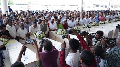 Mr Vijayan and others pay homage to the victims. EPA