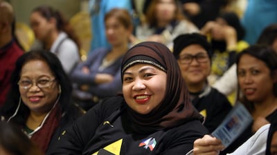 Members of the Filipino community working and residing in Kuwait attend a meeting with their country's Labour Department Undersecretary for Workers Protection at the Philippines' Embassy in Kuwait City. AFP/YASSER AL-ZAYYAT