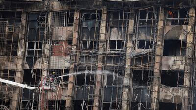 Efforts to douse a fire that broke out at police headquarters in Ismailia, Egypt. Reuters