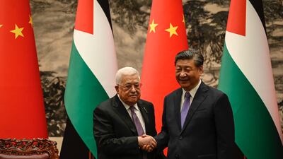Palestinian President Mahmoud Abbas shakes hands with China’s President Xi Jinping after a signing ceremony at the Great Hall of the People in Beijing. Getty