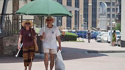 As temperatures and humidity rise, UAE residents and visitors should take suitable precautions when out in the midday sun. Razan Alzayani / The National