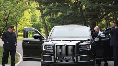 Mr Putin presents a luxury car made by Russian maker Aurus to Mr Kim. EPA / Sputnik / Kremlin pool