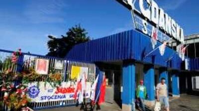 Flowers, a photo of Pope John Paul II and Solidarity banners adorn the entry to the Gdansk shipyard, where Solidarity was formed in 1980.
