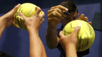 Serbia's Novak Djokovic signs autographs after winning his quarter-final match against Japan's Kei Nishikori at the Australian Open tennis tournament at Melbourne Park, Australia, January 26, 2016. REUTERS/Brandon Malone TPX IMAGES OF THE DAY