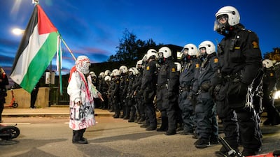 A pro-Palestinian protester faces off with police outside Ullevaal Stadium during the World Cup qualifying football match between Norway and Israel in Oslo. PA