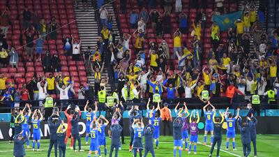 Ukraine players celebrate with fans after the match at Hampden Park in Glasgow, Scotland. Reuters