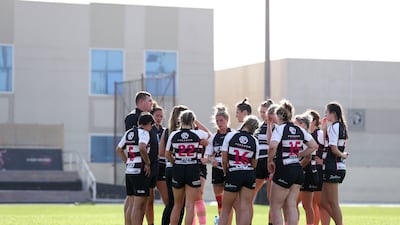 Dubai Falcons players huddle for a team talk with their coach during the game against Al Maha. Khushnum Bhandari / The National