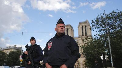 Police officers seal off the access to Notre Dame cathedral, seen in the background, after a man attacked officers with a hammer outside the famous landmark, in Paris, France, on June 6. Christophe / AP Photo