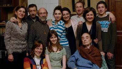 Two families become one: Denise Roig (seated left) and husband Ray Beauchemin (with beard), adopted Georgia (centre) in 1995. Her nurse was Olga Kartsivadze (seated). Other family members, standing from left: Tamar Kartsivadze, Lado Kuparadze, Liza Kuparadze, her mother Eka Kartsivadze, Eka's brother David, and his children (with Tamar) Sopiko and Sandro.