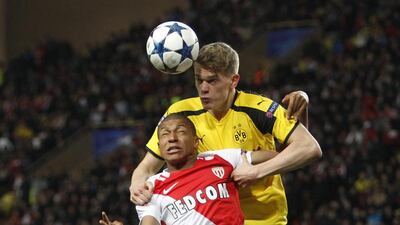 Monaco's Kylian Mbappe, front, and Dortmund's Matthias Ginter fight for possession. Claude Paris / AP Photo
