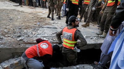 Rescue workers search the rubble in Peshawar. Reuters