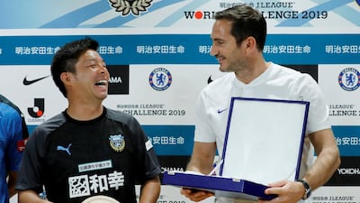 Chelsea manager Frank Lampard exchanges souvenirs with Kawasaki Frontale manager Toru Oniki. Reuters