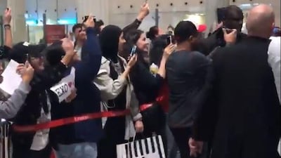 Fans wait for the arrival of Korean boy band Exo at the Dubai International Airport.