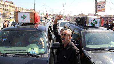 The Iraqi flag-draped coffins of the two protesters killed in Baghdad on Friday are driven through the capital's streets during their funeral procession on Saturday. Karim Kadim/AP Photo
