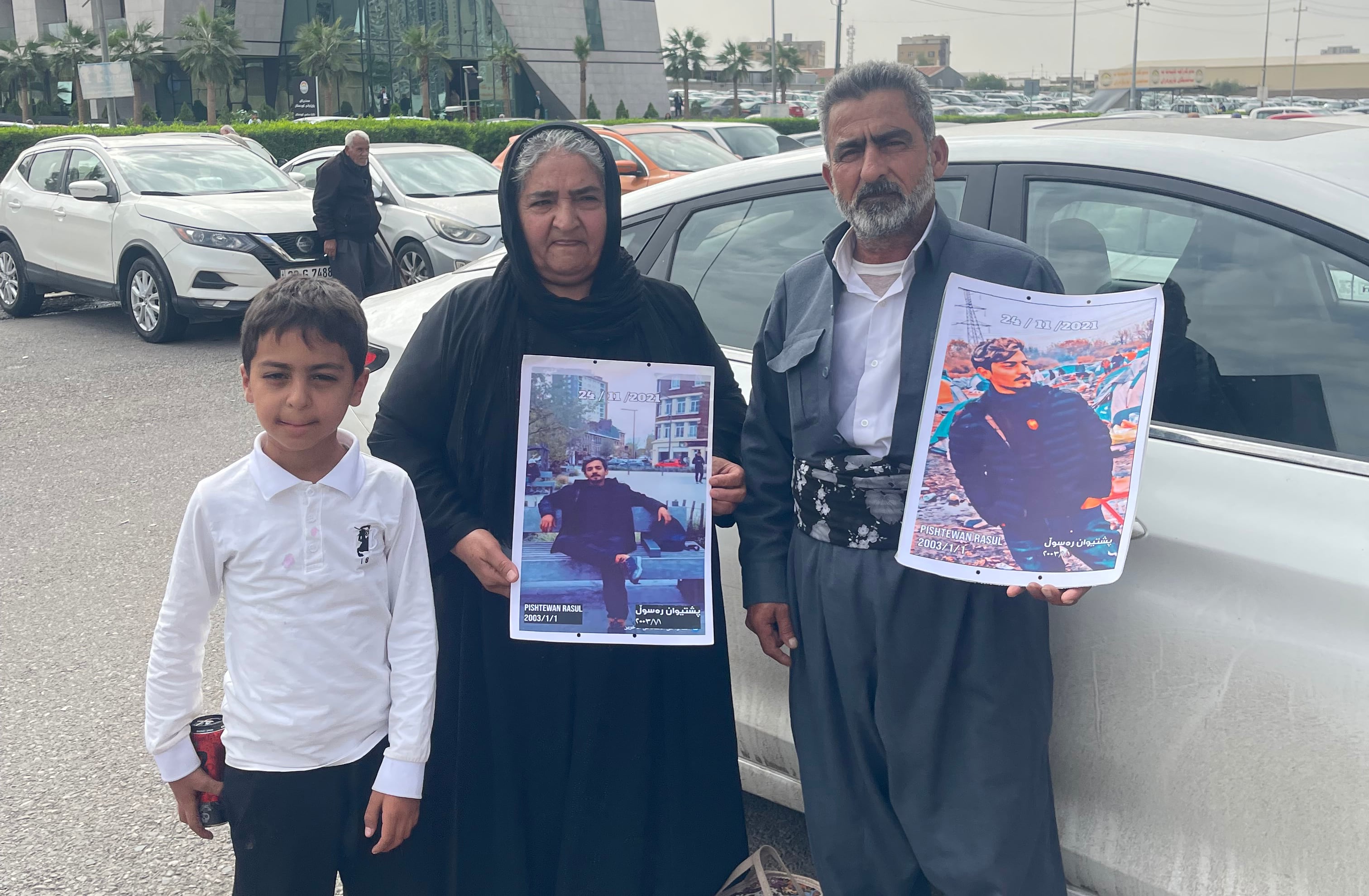 Pshtiwan Farka's parents hold photographs of him. Aveen Karim/The National