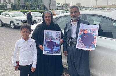 Pshtiwan Farka's parents hold photographs of him. Aveen Karim/The National