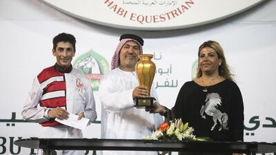 Trainer Jaber Bittar, centre, pictured in November 2013, saddled two winners on December 21 at the Abu Dhabi Equestrian Club, including one ridden by jockey Jesus Rosales, left. Lee Hoagland / The National