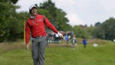 Rory McIlroy of Northern Ireland shouts to warn spectators of a wayward ball on the third hole during the second round of the British Open. McIlroy has had trouble keeping his ball in the fairway and even hit a spectator on Thursday.