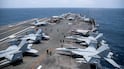 Navy sailors on aircraft carrier USS George Washington on August 20, as it transits the Arabian Sea to support US military operations in the war with Iran. Reuters