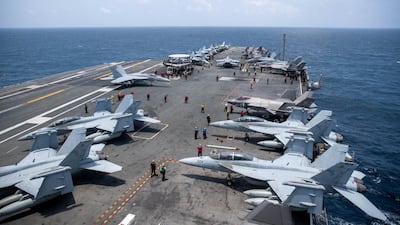 Navy sailors on aircraft carrier USS George Washington on August 20, as it transits the Arabian Sea to support US military operations in the war with Iran. Reuters