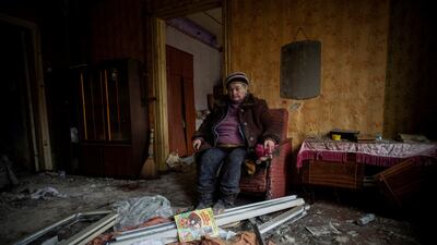 Natalia, 67, sits inside her house that was damaged in a Russian military strike, in Kramatorsk, Ukraine. Reuters