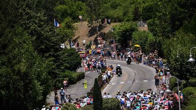 Cyclists ride during the 10th stage of the Tour de France between Annecy and Le Grand-Bornand. Jeff Pachoud / AFP