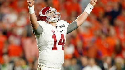 Jake Coker #14 of the Alabama Crimson Tide celebrates after Derrick Henry #2 scored a one yard touchdown in the fourth quarter against the Clemson Tigers during the 2016 College Football Playoff National Championship Game at University of Phoenix Stadium on January 11, 2016 in Glendale, Arizona. Christian Petersen/Getty Images/AFP