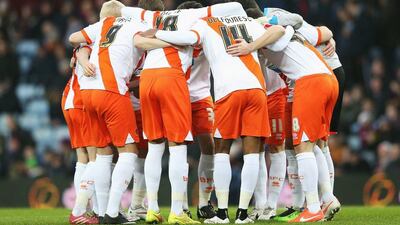 Blackpool players huddle during the FA Cup third round match against Aston Villa on Sunday. Clive Mason / Getty Images
