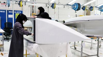 Employees work on parts for Airbus and Boeing in the Assembly section at the Strata Manufacturing facility in Al Ain. Pawan Singh / The National