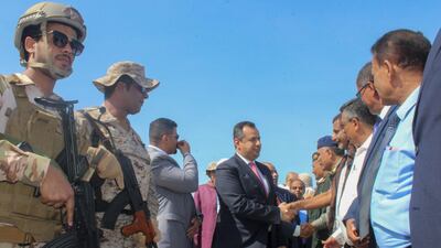 Yemen's Prime Minister Maeen Abdulmalik Saeed greets officials after arriving at Aden airport on November 18, 2019. AFP