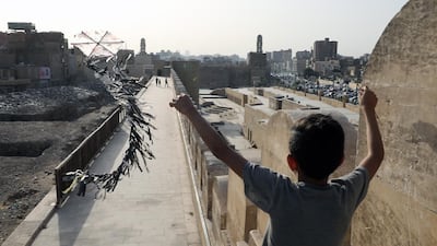 A boy flies a kite in Cairo. Banks in the country are expected to remain stable despite the coronavirus inflicted slowdown. EPA